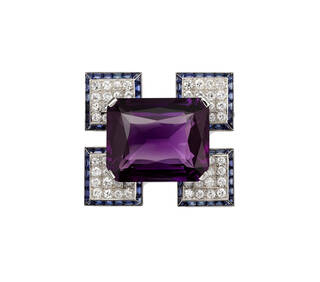 Brooch with four diamond encrusted squares surrounding a large rectangular purple stone