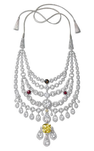 elaborate necklace with many tiers of diamonds in rows and with drops with a large yellow stone at the bottom and a tie