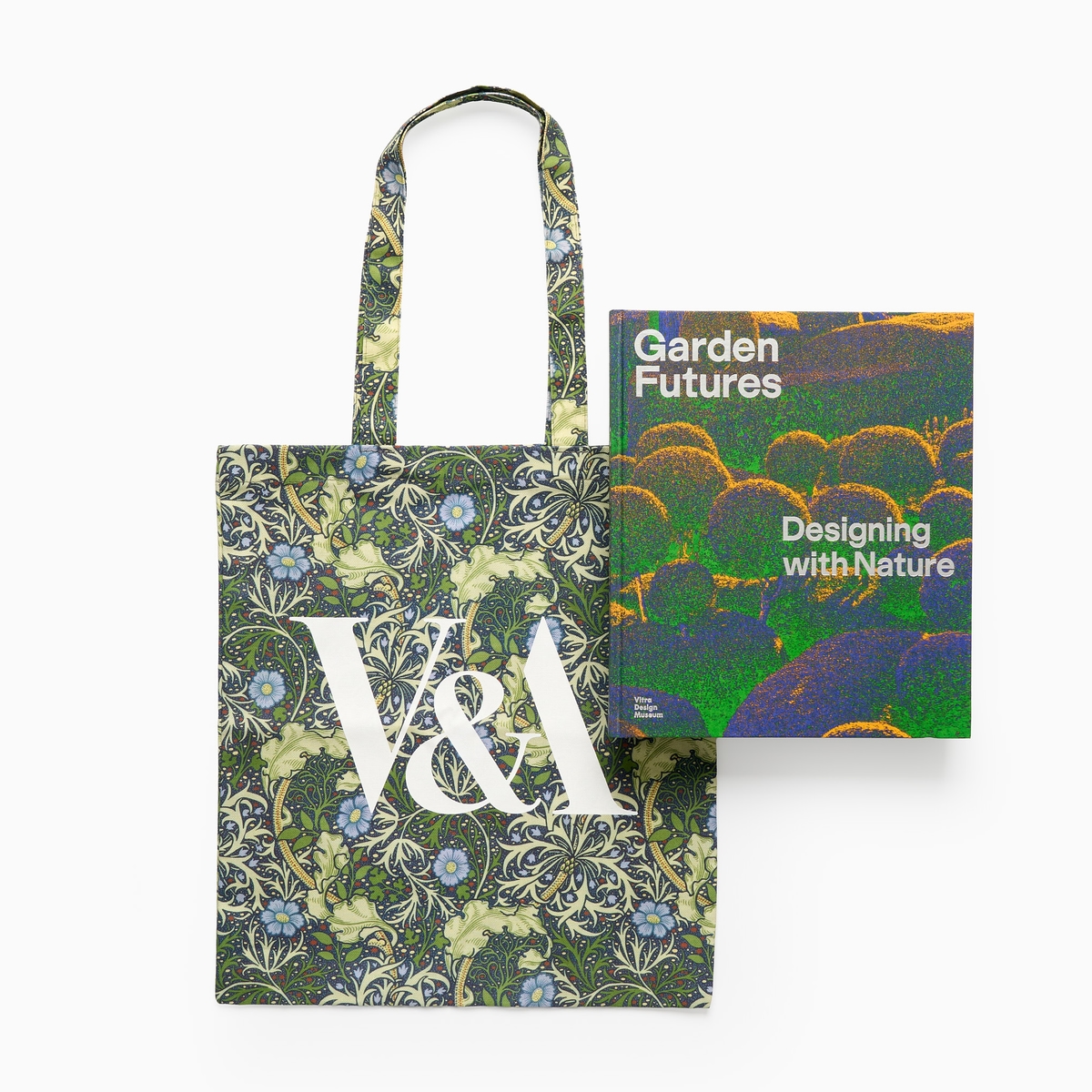 A floral tote bag with a green exhibition book titled 'Garden Futures: Designing with Nature;