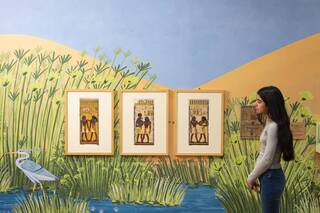 Girl looks at the Young V&A Makiong Egypt wall exhibit